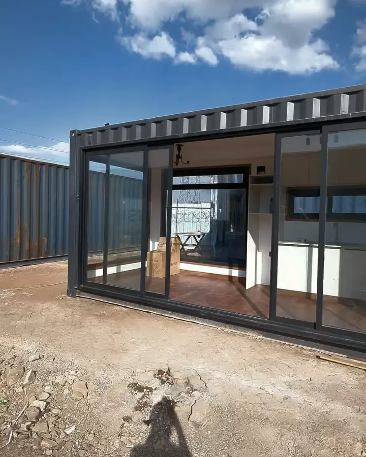 Finished container conversion exterior with full-height glass sliding doors