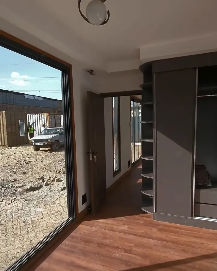 Container conversion living space with glass doors and built-in shelving