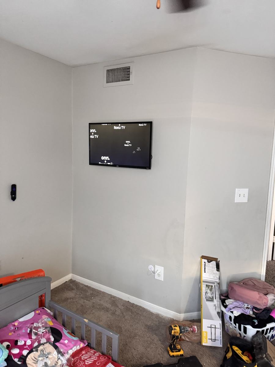 TV mounted and powered on with Roku home screen, after install