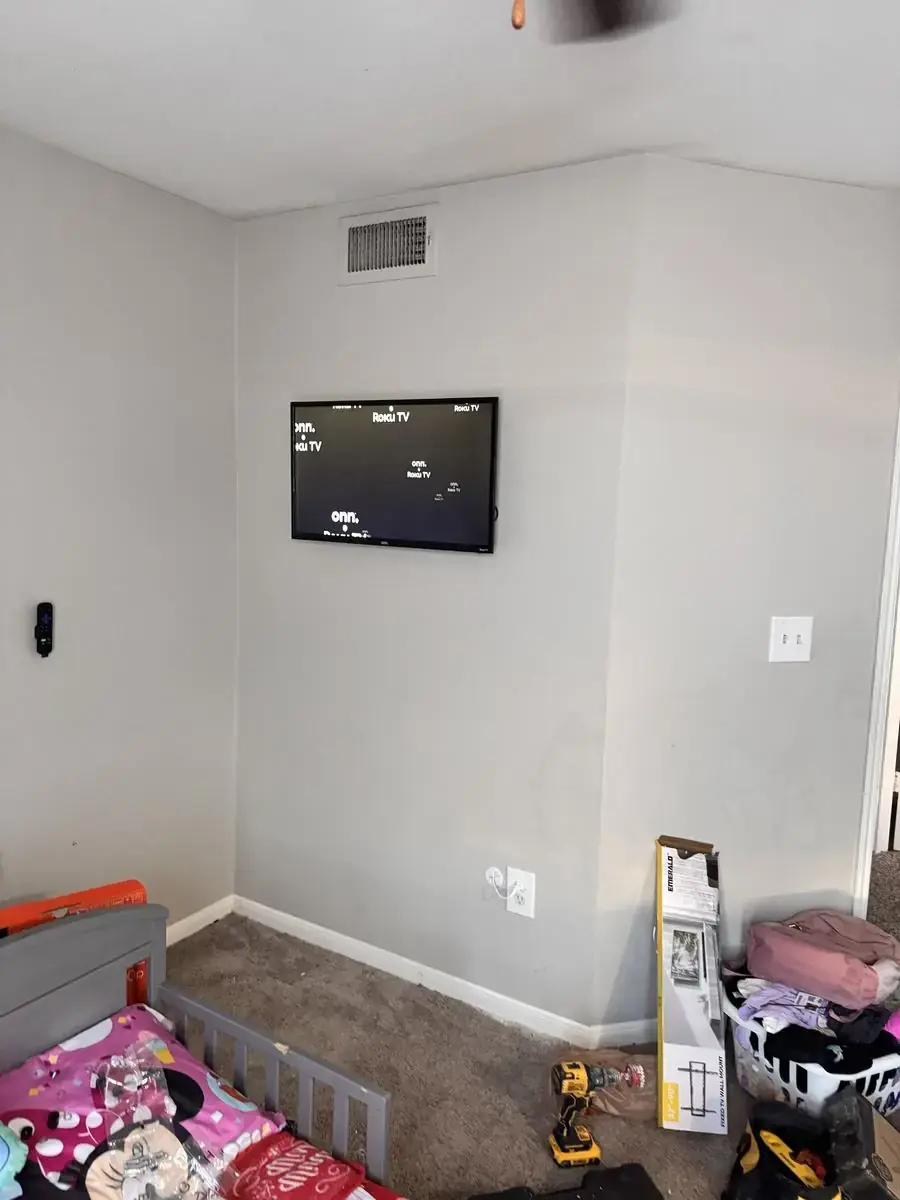 TV mounted and powered on with Roku home screen, after install