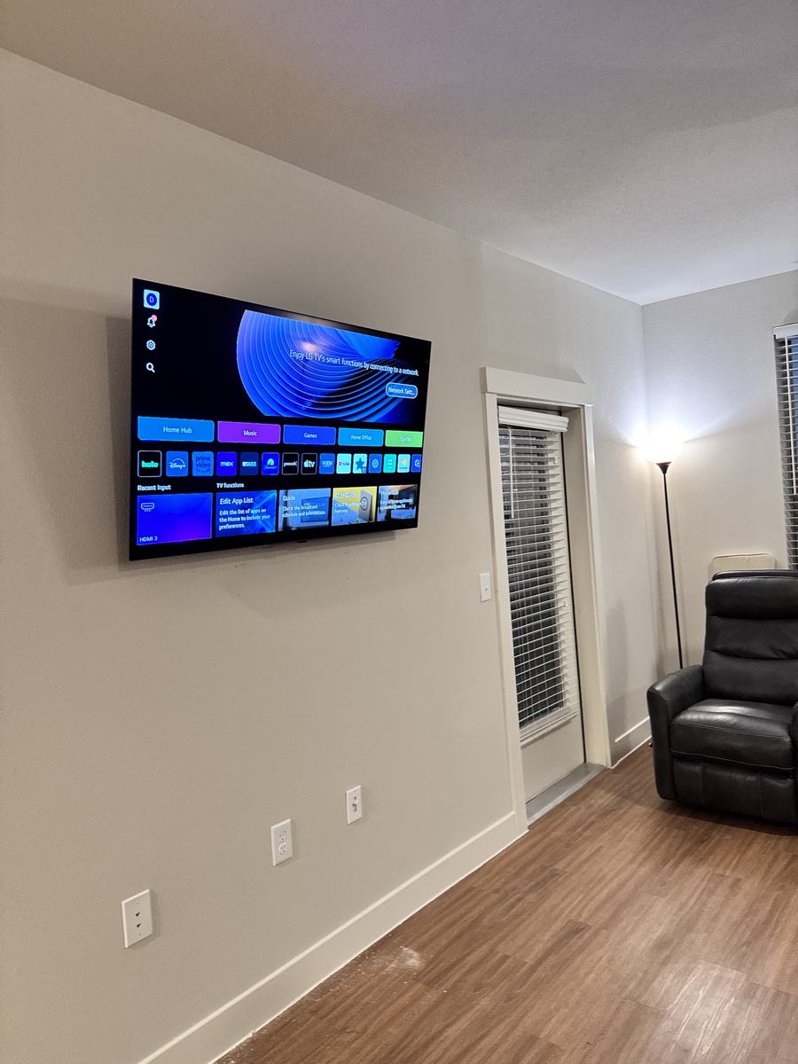 Same wall with TV mounted level and centered, wires hidden, finished install