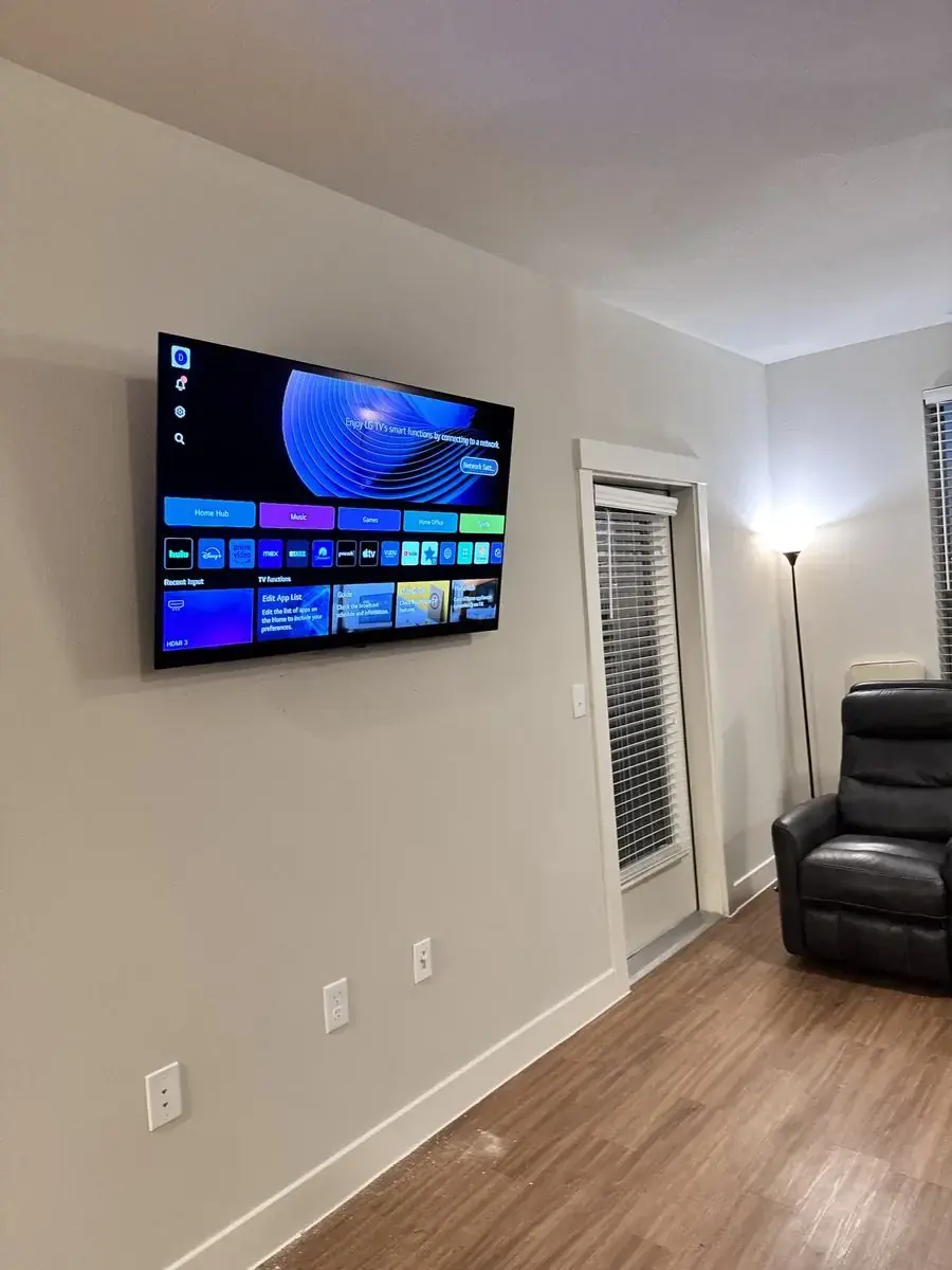 Same wall with TV mounted level and centered, wires hidden, finished install