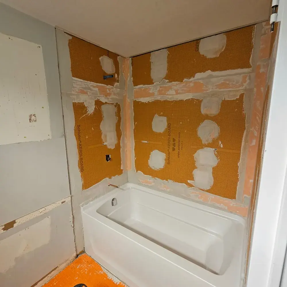 Shower walls waterproofed with Schluter-Kerdi-Board membrane before tile