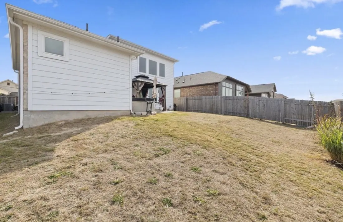 Backyard lawn with a privacy fence