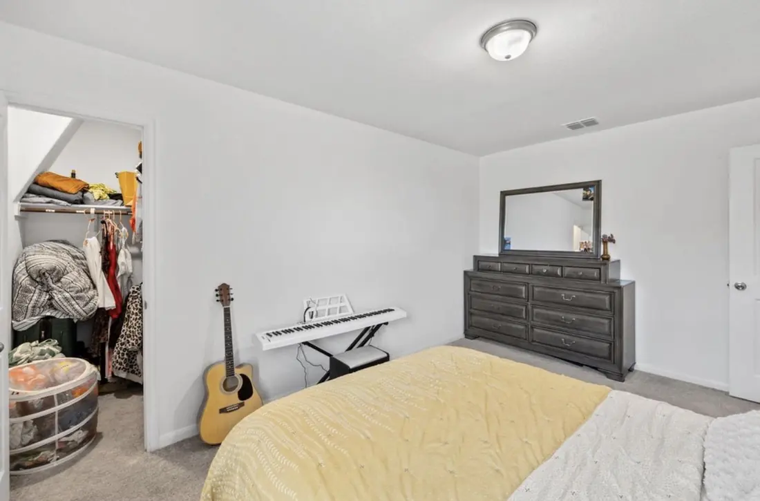 Same bedroom, showing the closet and dresser space