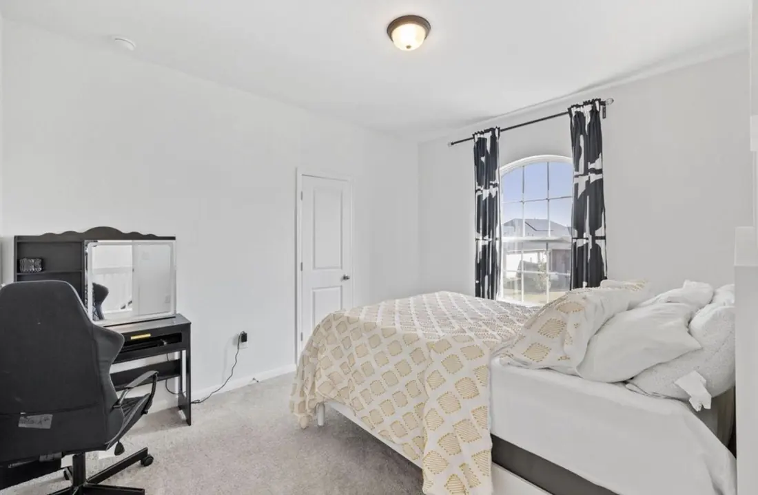 Bedroom set up with a desk, ideal as a home office