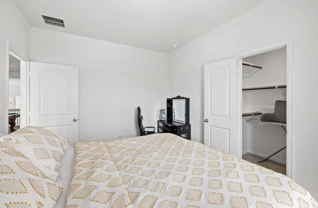 Bedroom with a desk and a walk-in closet