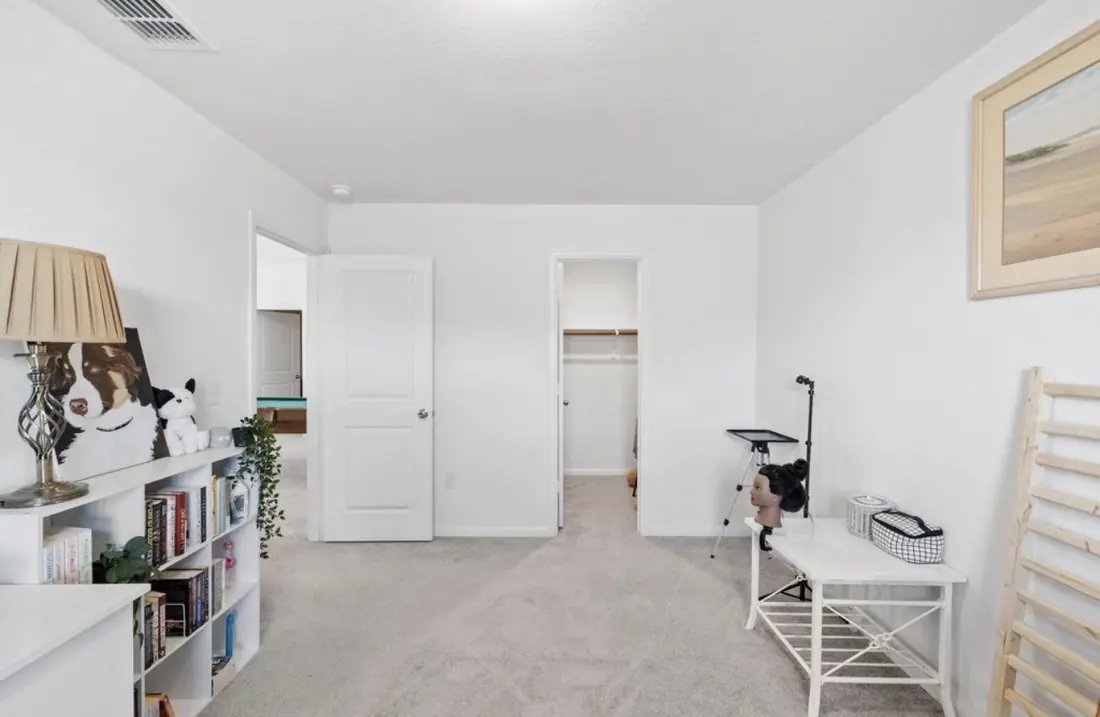 The fifth bedroom, another angle, with a bookshelf and seating area