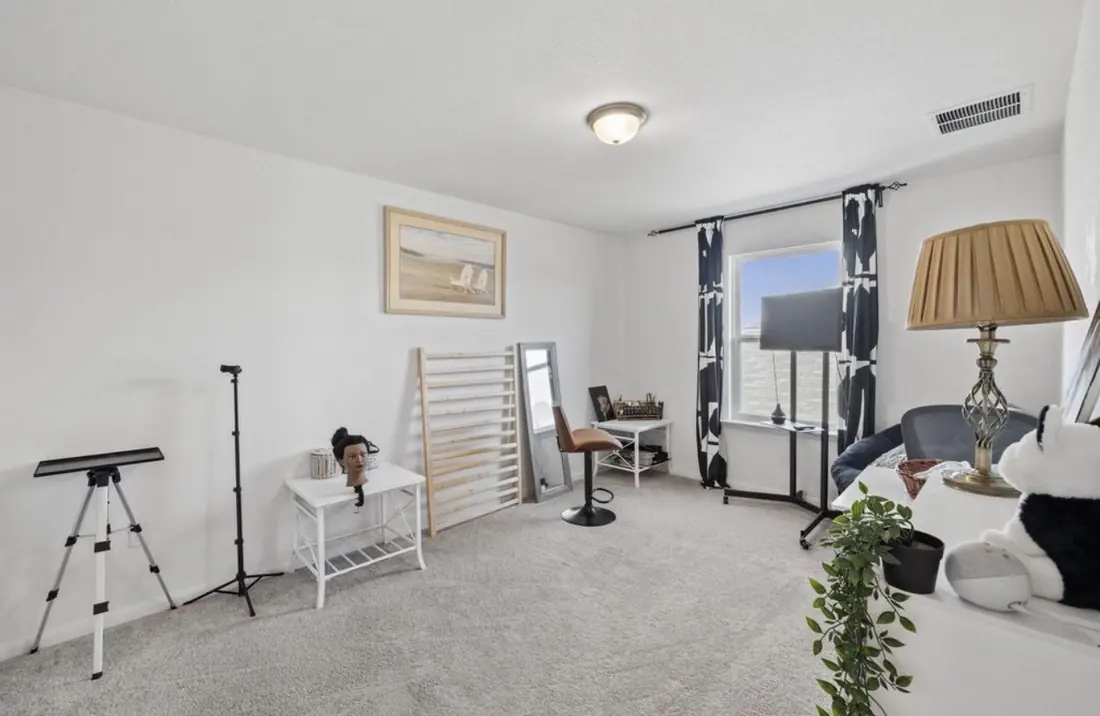 Fifth bedroom set up as a creative workspace with a window