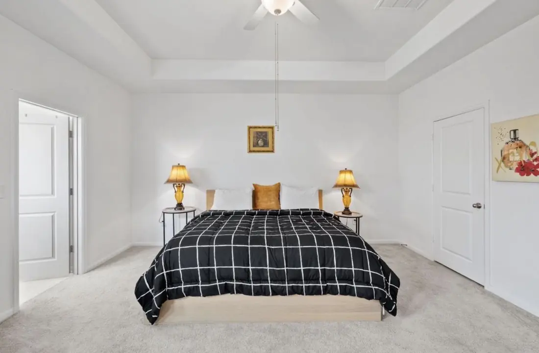 Primary bedroom with a tray ceiling