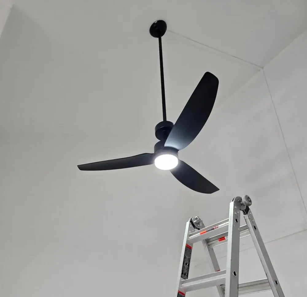 Finished black 3-blade ceiling fan with integrated LED light, running