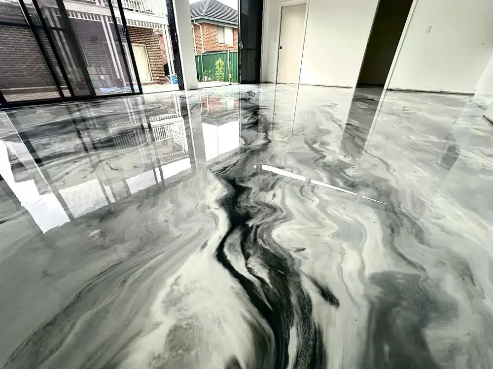 Metallic epoxy floor coating installed through an open-plan hallway and living space