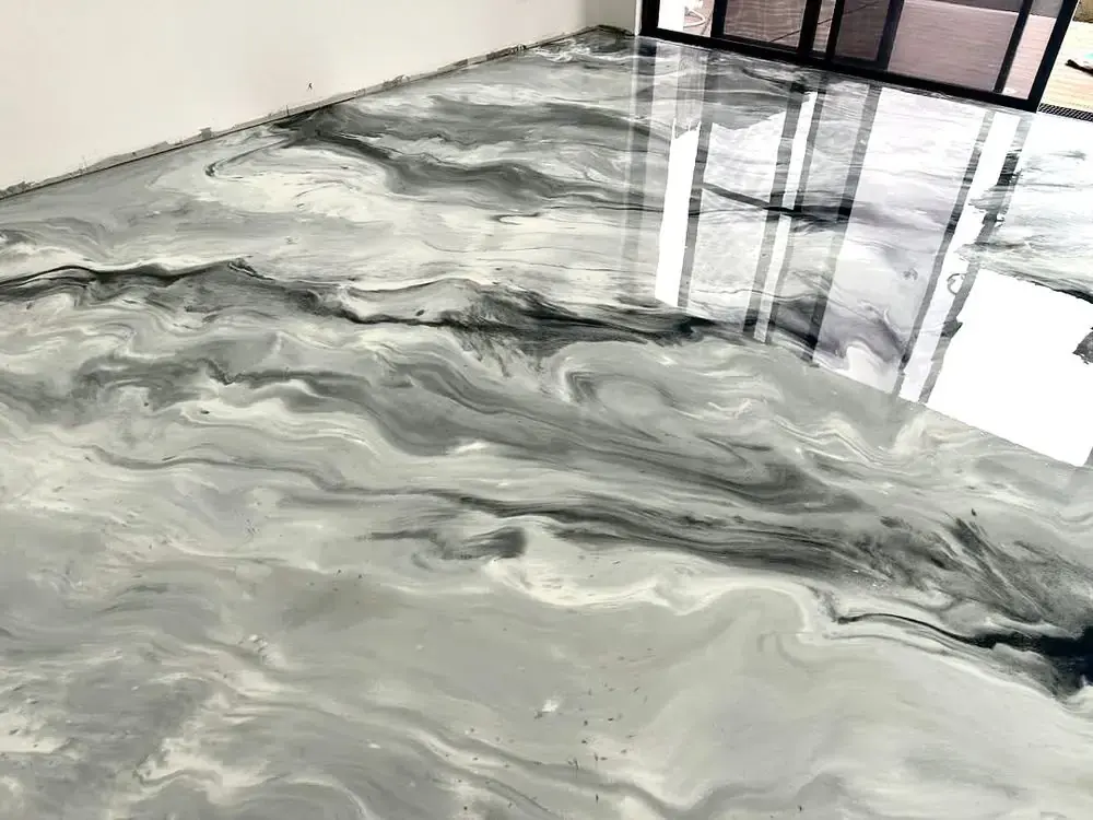 Close-up of marbled metallic epoxy floor coating showing the swirl detail