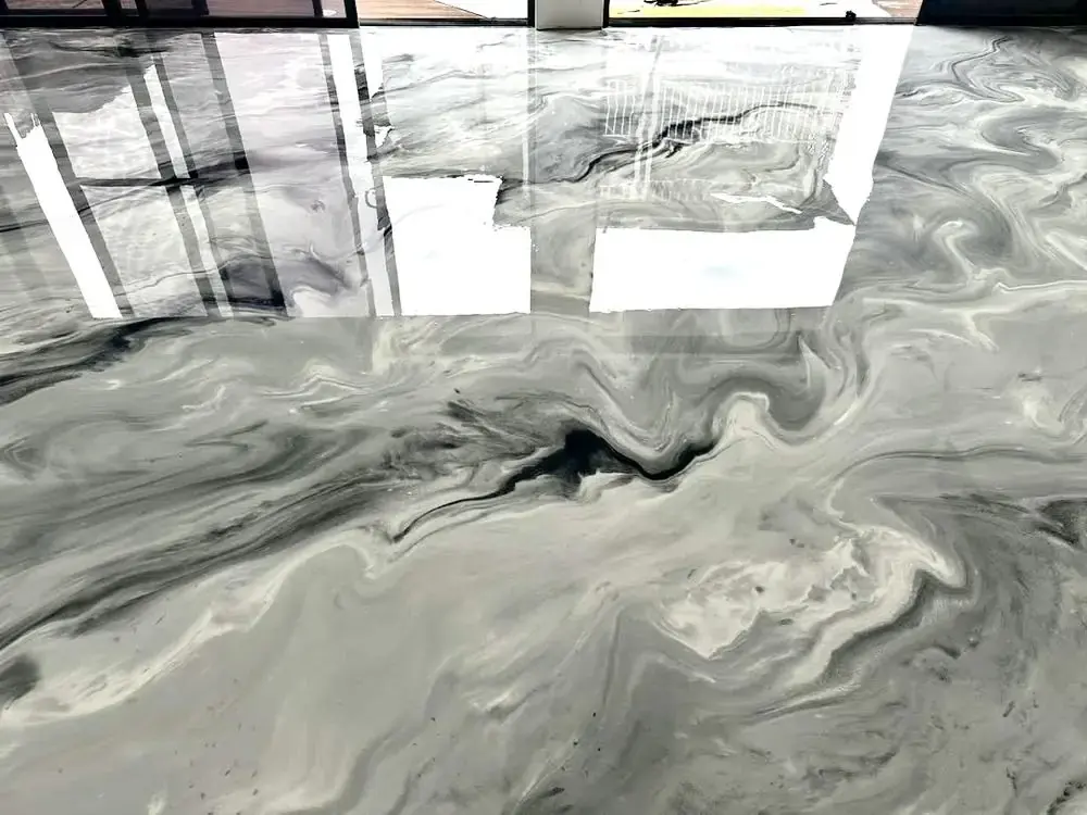 Metallic epoxy floor coating with reflective gloss finish and marbled gray tones