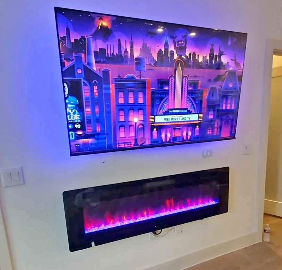 TV mounted above an electric fireplace insert with wires routed clean