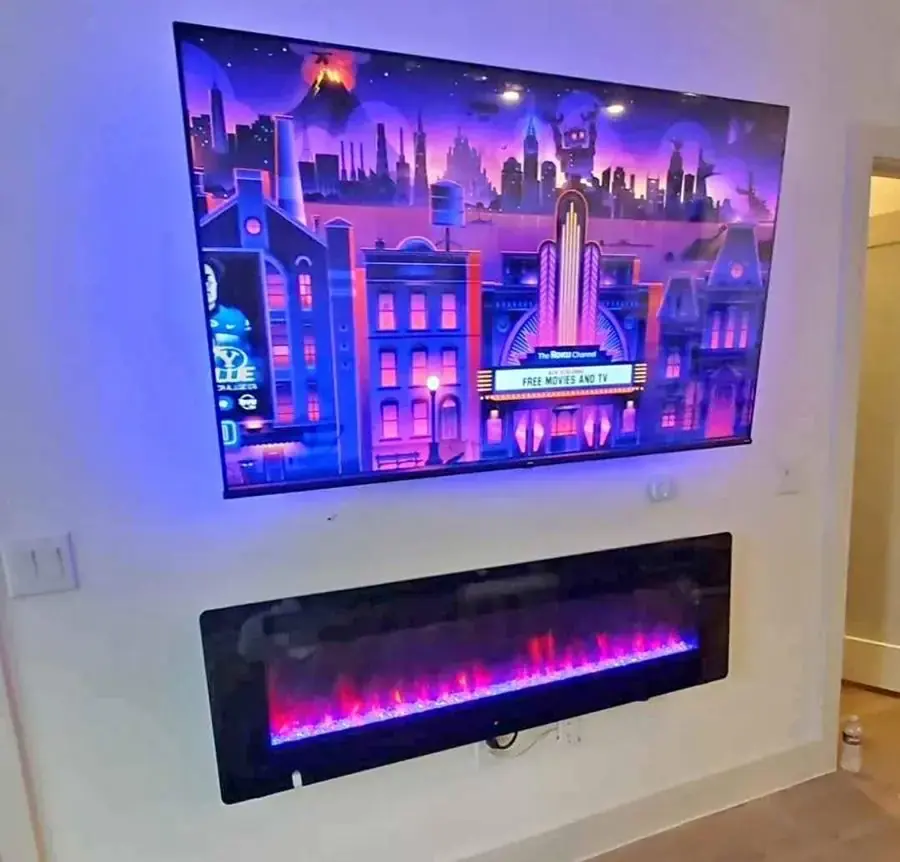 TV mounted above an electric fireplace insert with wires routed clean