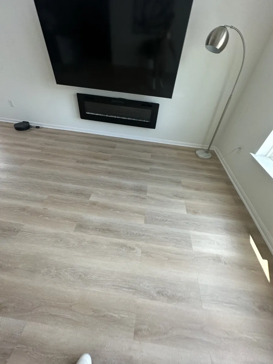 Living room with new light wood-look vinyl plank flooring