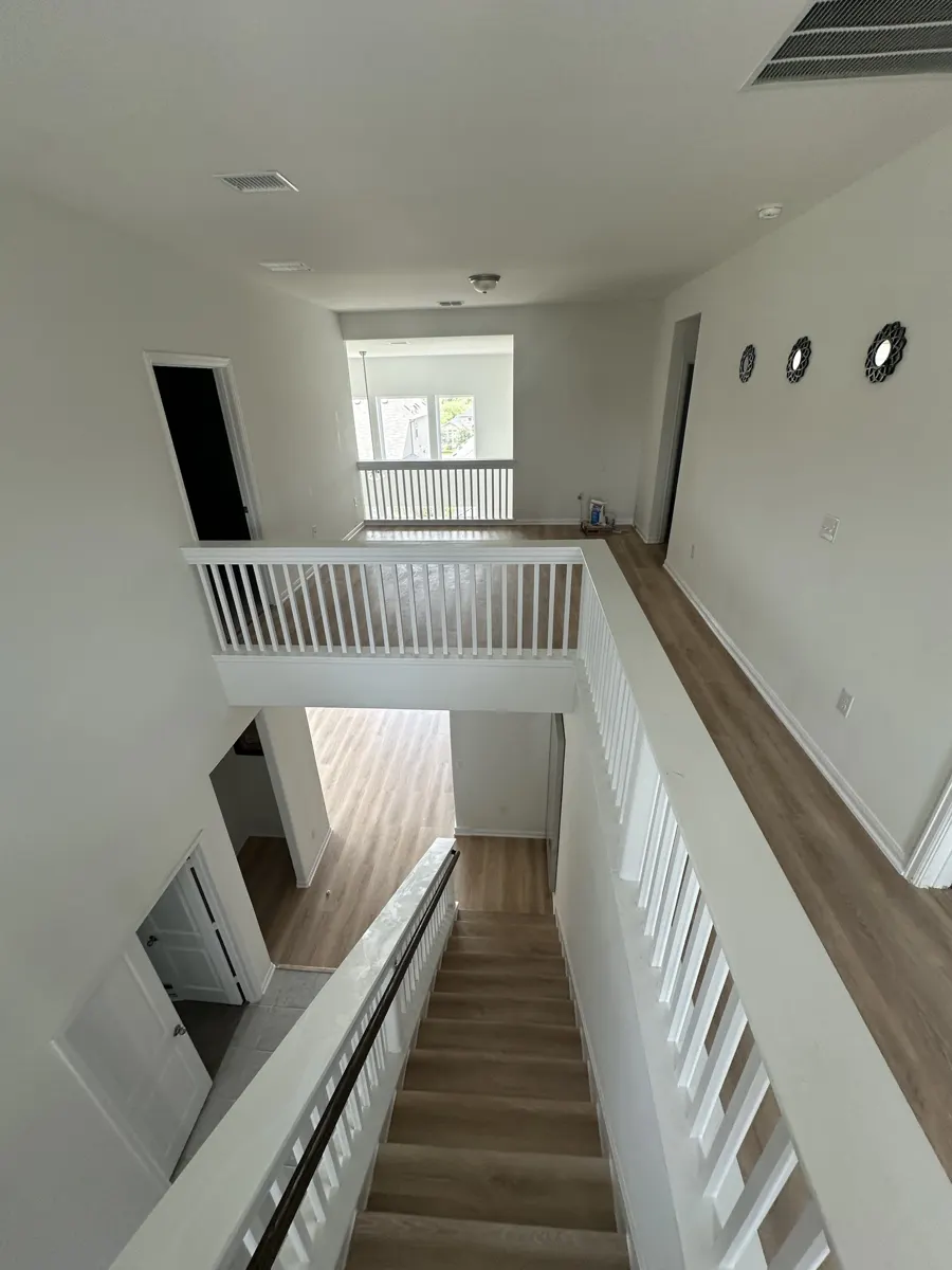 The same loft and hallway finished with continuous luxury vinyl plank flooring