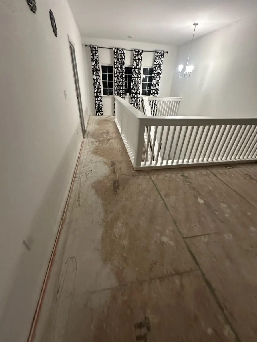 Upstairs loft and hallway with bare subfloor after carpet removal