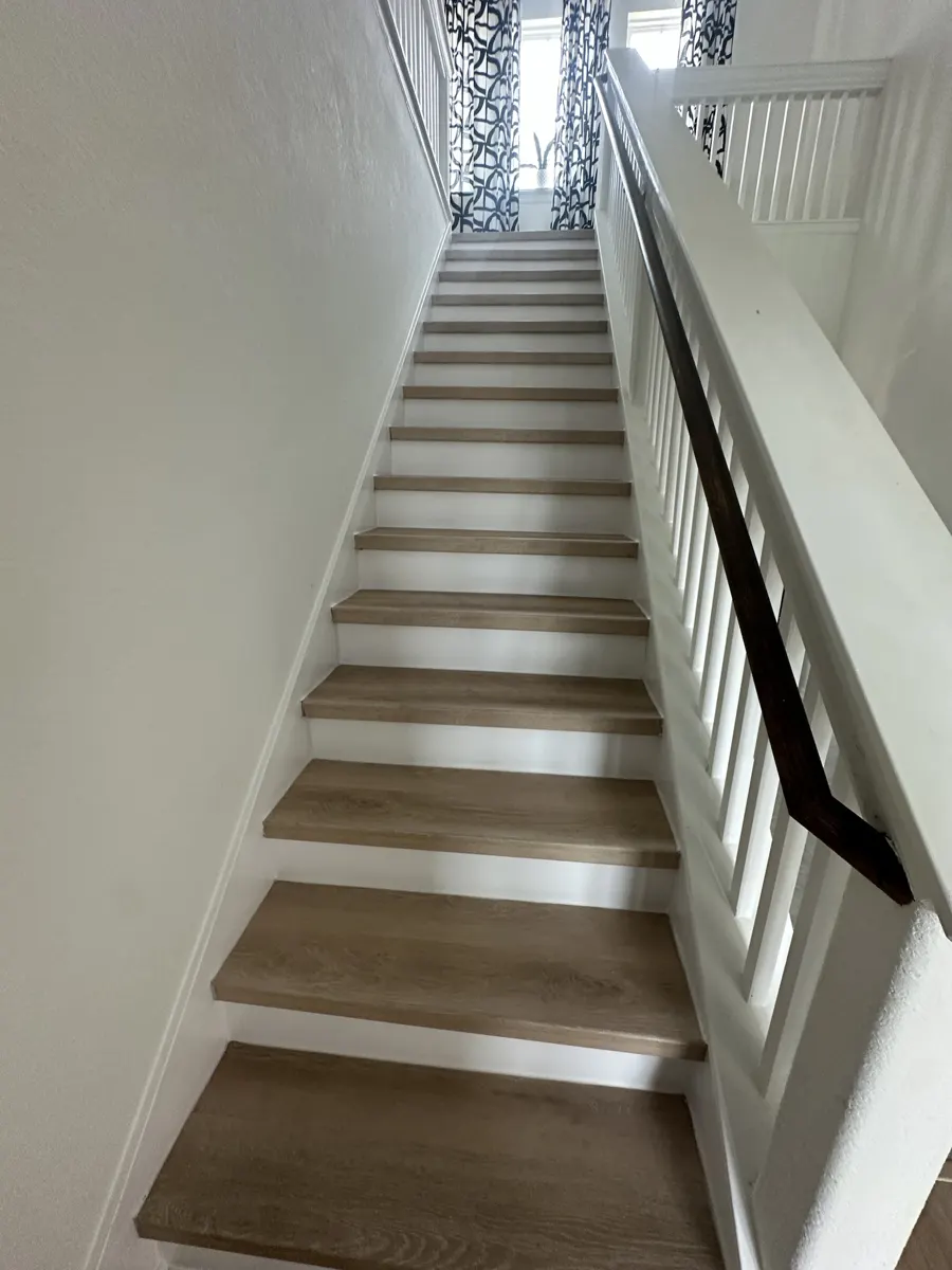 Finished stairs with wood-look treads and white painted risers