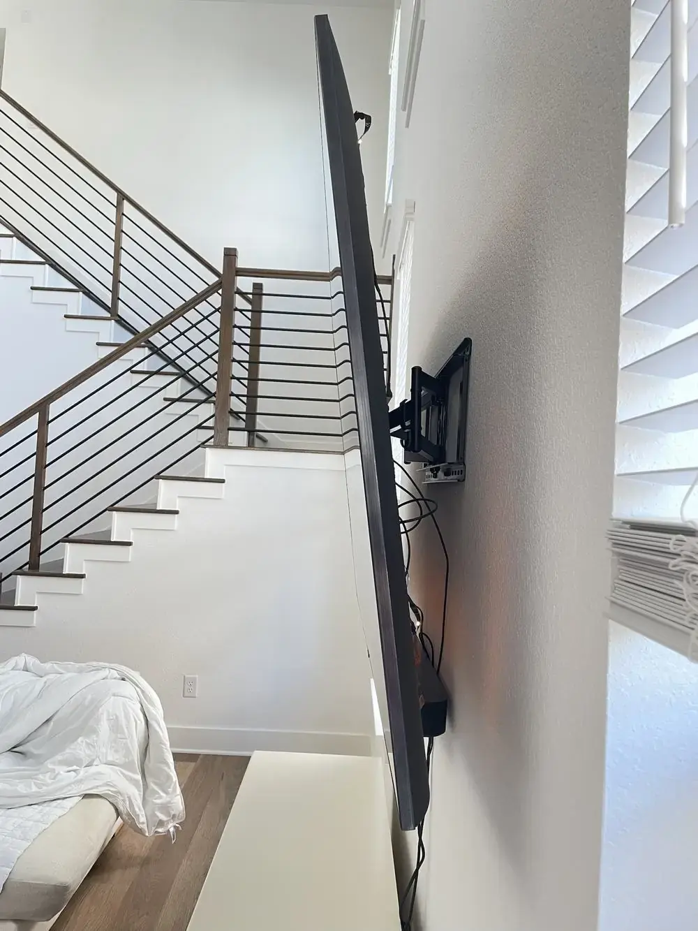 Side profile of a TV pulled out on a full-motion articulating swing-arm wall mount