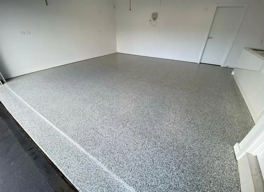 Finished garage with gray flake chip epoxy floor coating, wide view