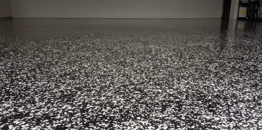 Macro close-up detail of black and white flake epoxy floor coating