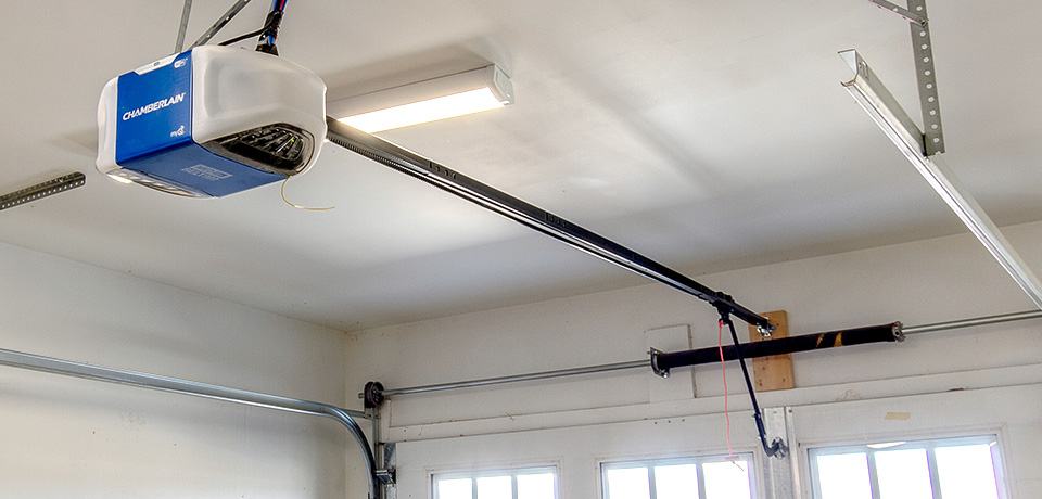 Finished garage door opener installation with rail and safety sensors set
