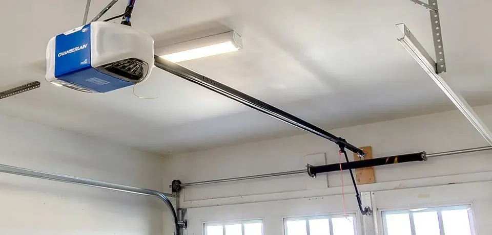 Finished garage door opener installation with rail and safety sensors set