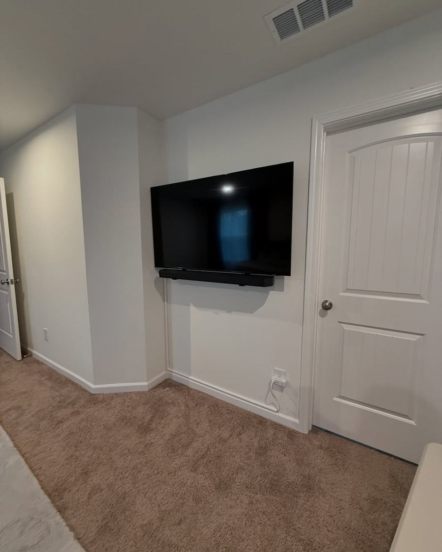 TV and soundbar mounted together in a tight corner, clean and level