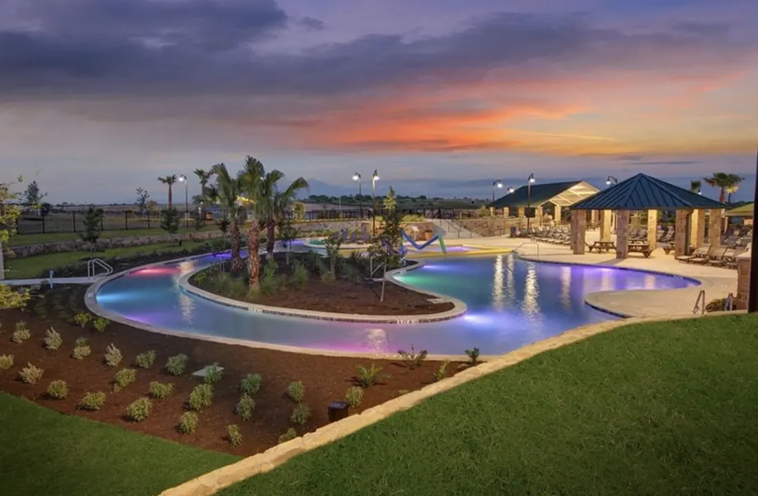 Sunset view of the Sunfield community lazy river and pavilion