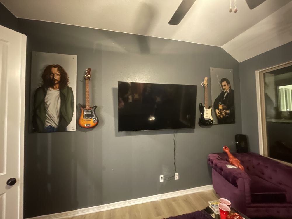 TV mounted between matching art panels on a dedicated media wall